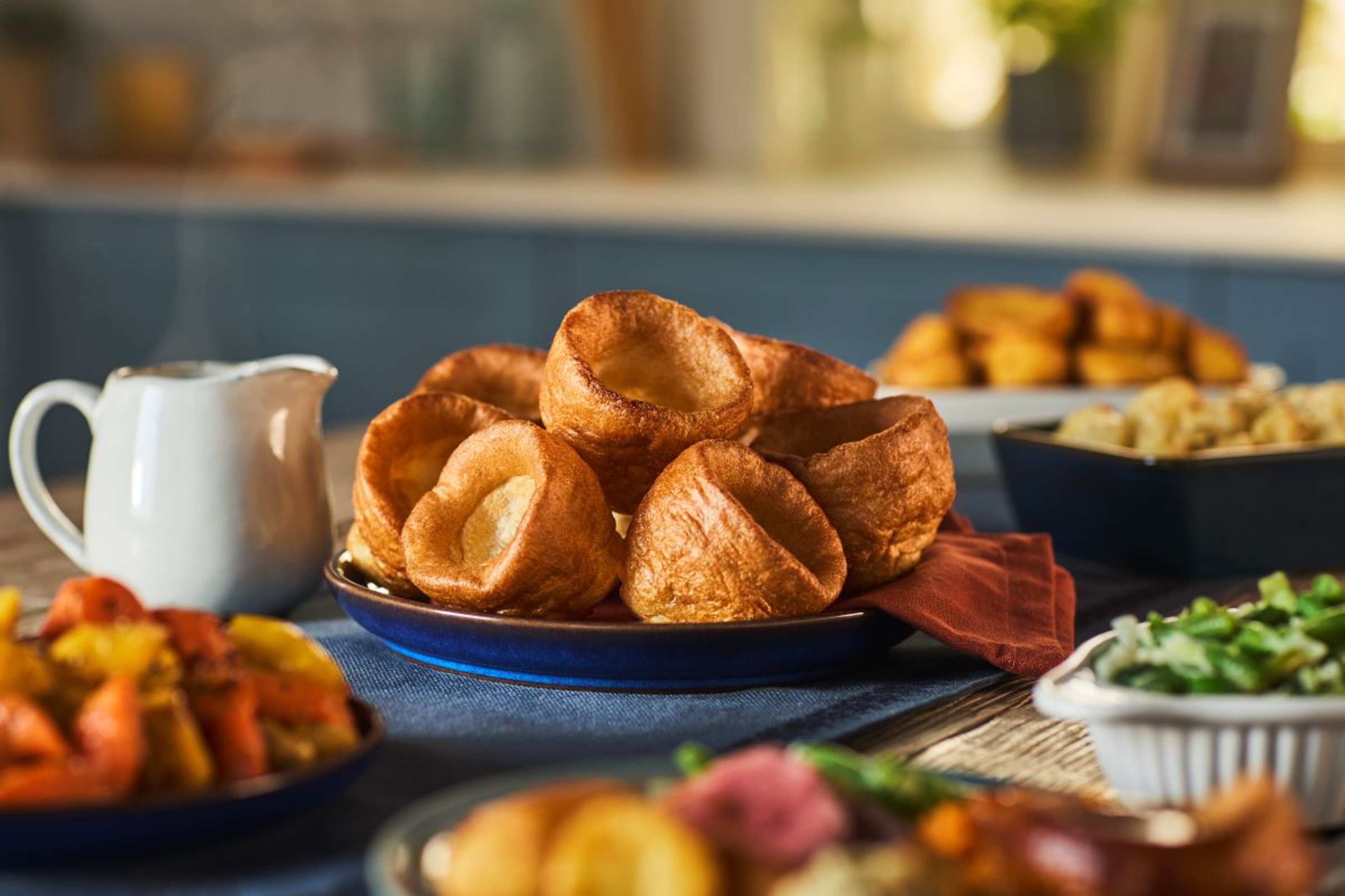 Roast dinner with gravy, Yorkshire puddings and vegetables